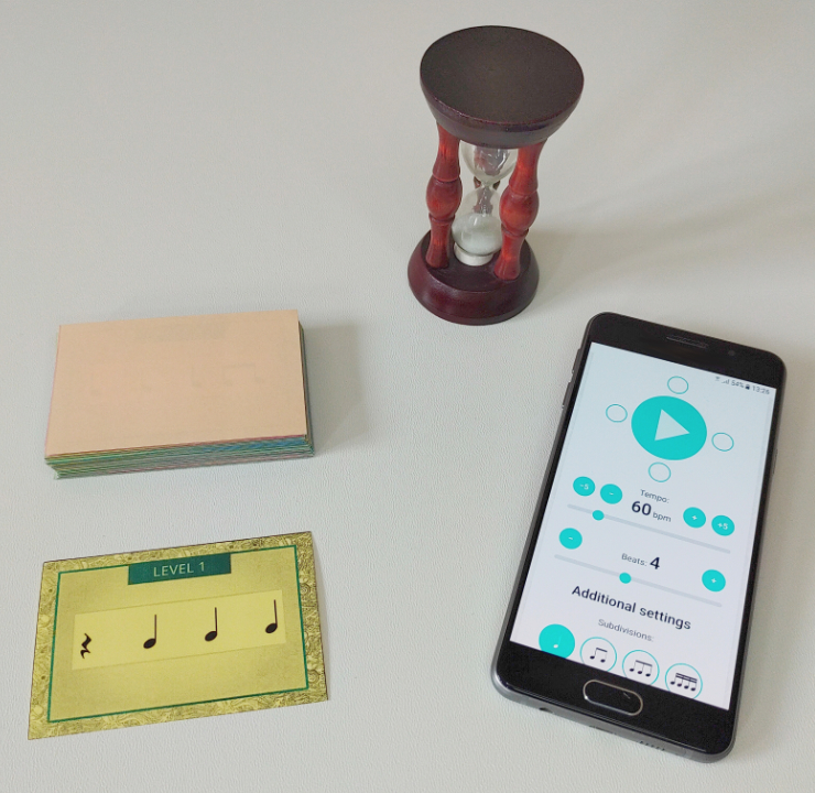 Rhythm Cards, a metronome and a hourglass prepared to play rhythm game