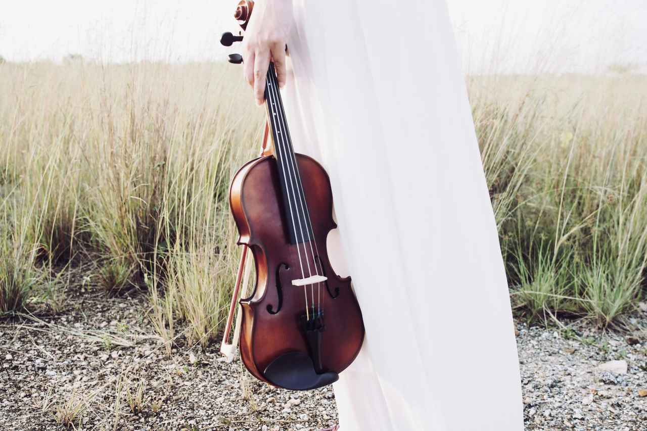 irish violin music - white dress woman holding a violin