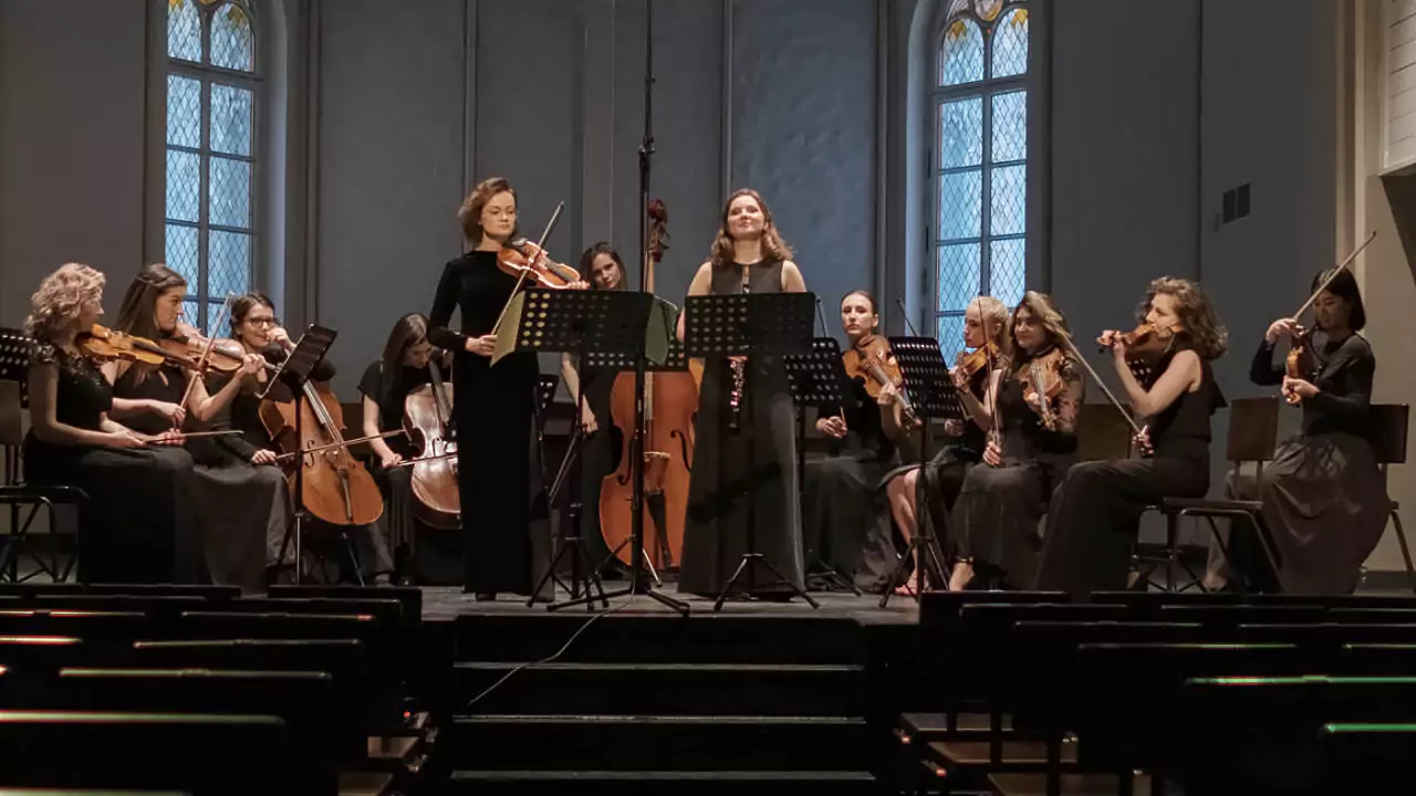 Symphony orchestra performing with violin, cello, and other orchestral instruments