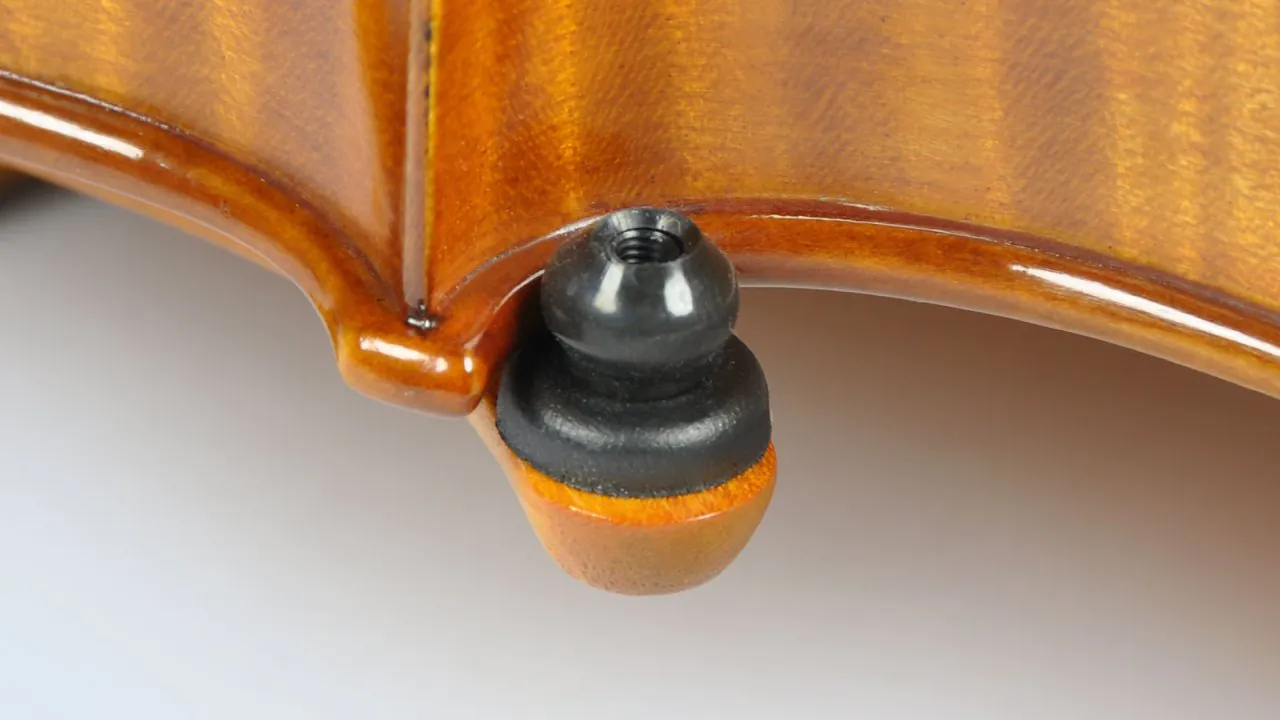 Close-up of the C-bout contact point on a violin.