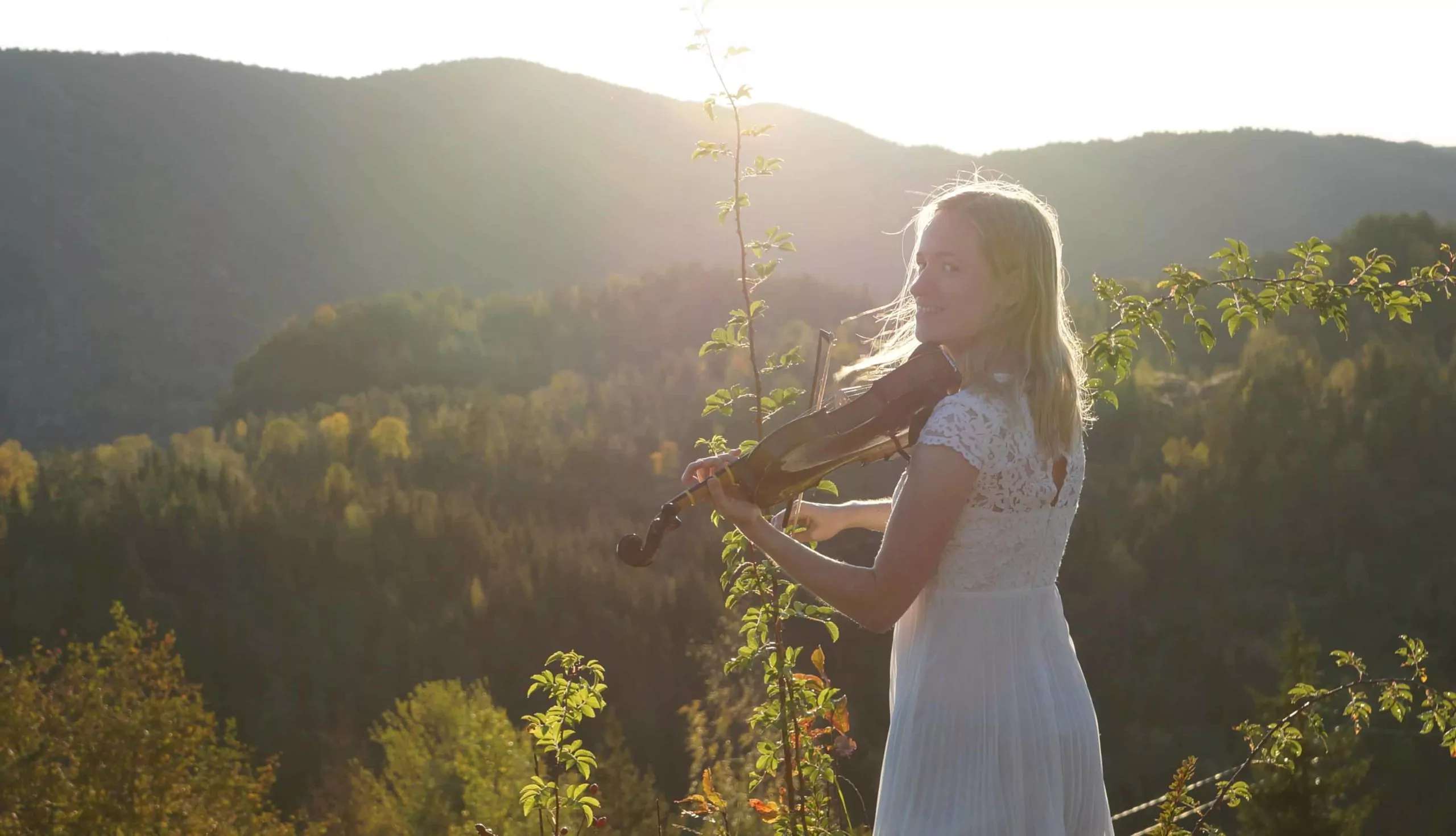 Julia Playing Violin Outdoors Julia playing the violin outdoors in the warm glow of the rising sun.