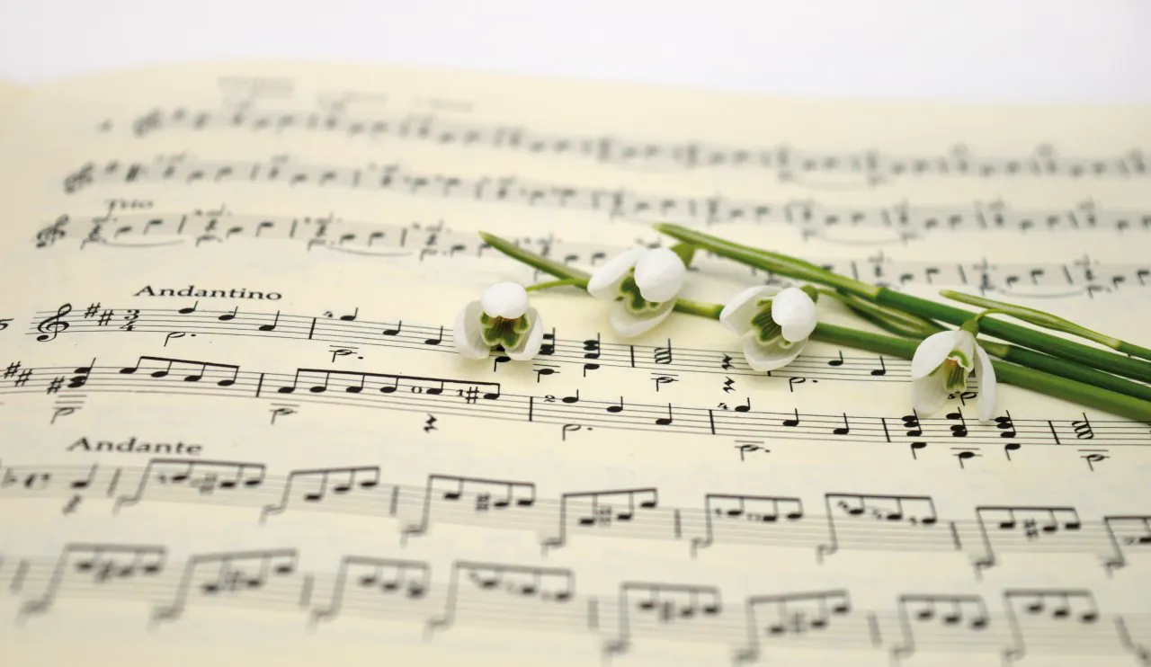 Violin sheet music with an iris flower