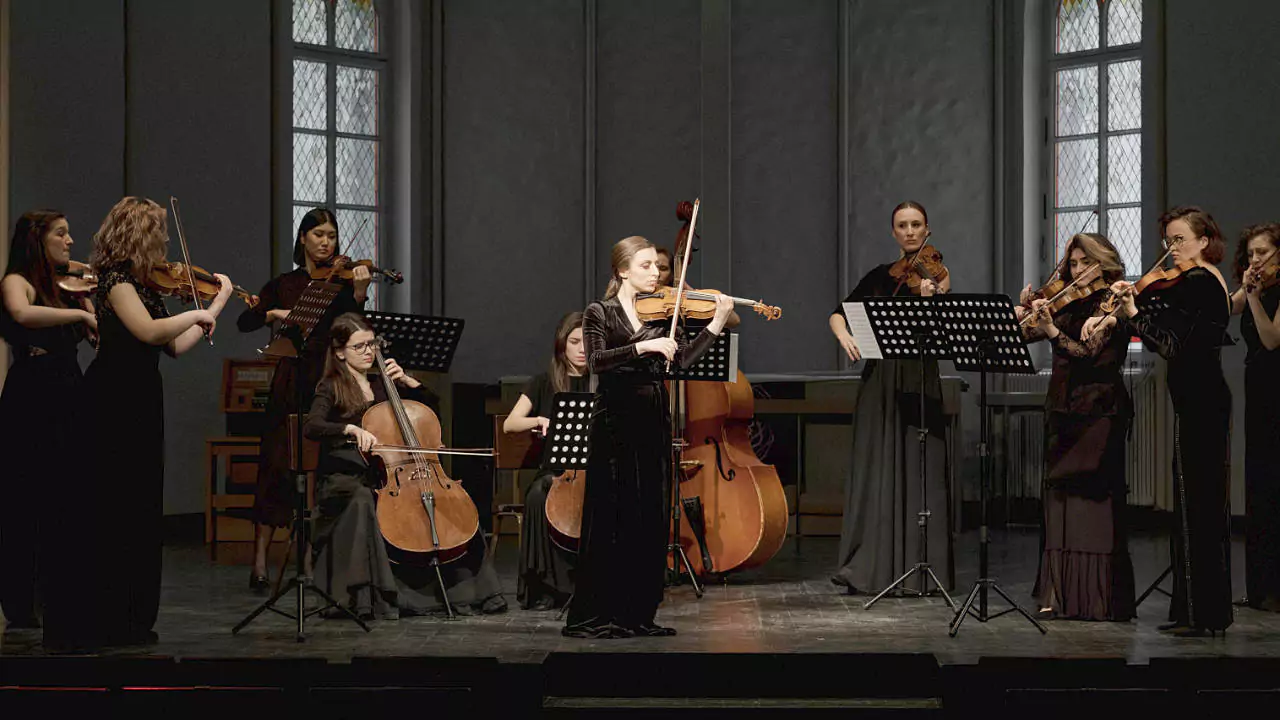 Violin soloist performing a concerto with an orchestra