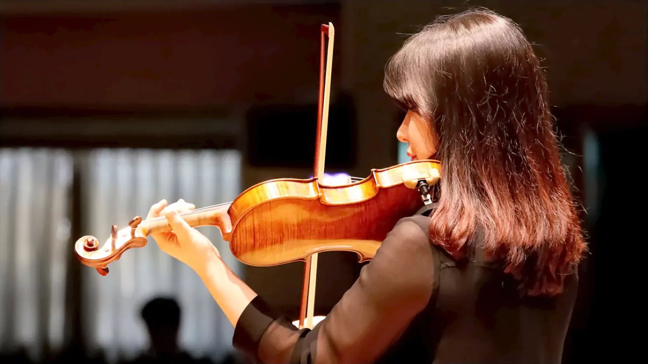 Woman playing the violin during a solo performance